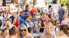 Large crowd with focus on couple drinking at the Downtown Fargo Street Fair