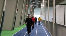 Several Adults walking on the indoor walking track at the Fargo Parks Sports Center.