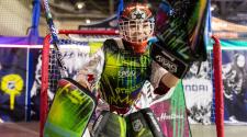 Child in goalie gear standing in front of goal for NHL Steet 