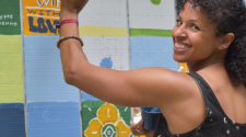 Photo of woman painting community mural