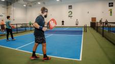 4 men playing pickleball on the Fargo Parks Sports Center pickleball courts