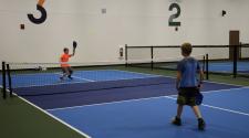 two boys playing pickelball on the Fargo Parks Sports Center pickleball courts