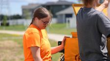 This graphic shows an intern working in a park.